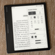 The Onyx Boox Leaf 2 e-reader on a wooden table with the Control Center menu open on-screen.